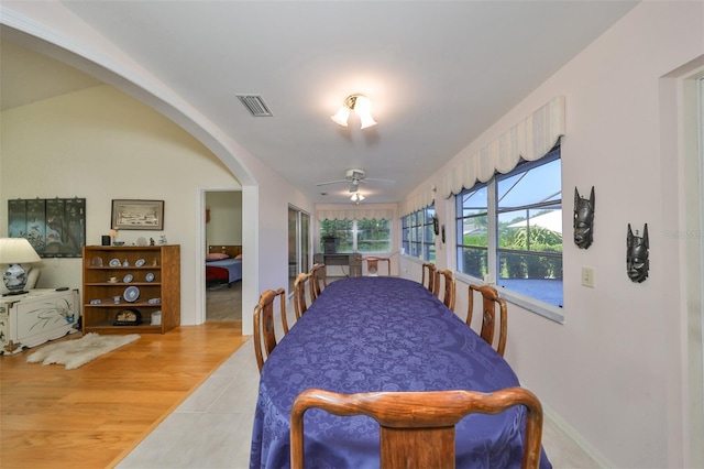 dining space with light hardwood / wood-style floors and ceiling fan