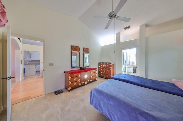 bedroom with ceiling fan, high vaulted ceiling, ensuite bathroom, and light hardwood / wood-style floors