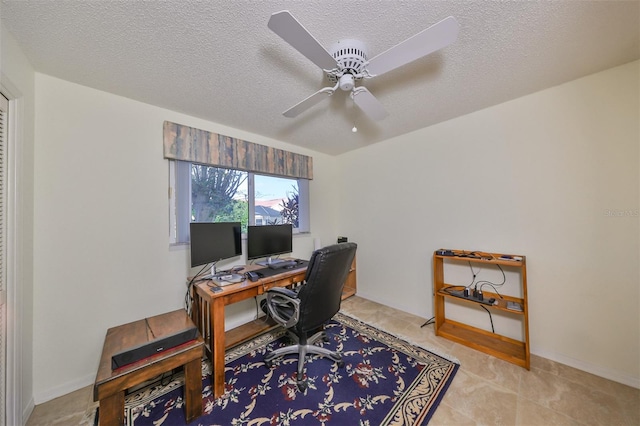 office area featuring ceiling fan and a textured ceiling