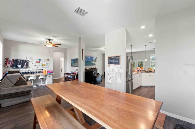 dining space featuring dark wood-type flooring and ceiling fan