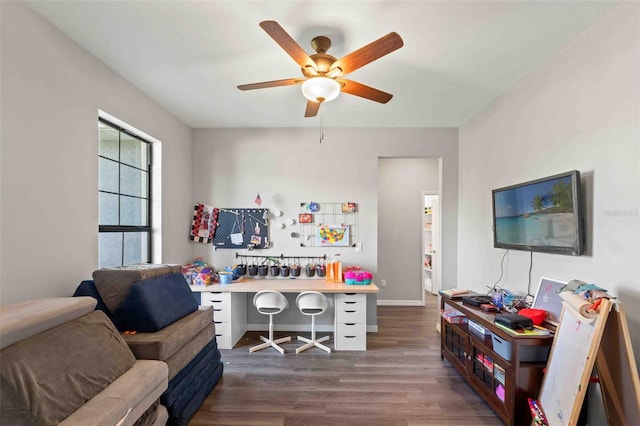 home office featuring dark wood-type flooring and ceiling fan