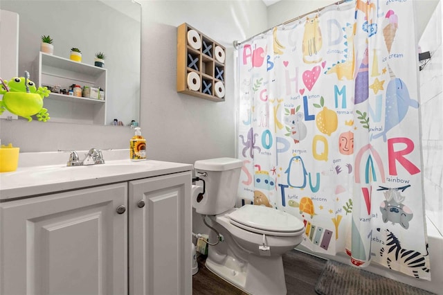 full bathroom featuring vanity, hardwood / wood-style flooring, shower / bath combo, and toilet