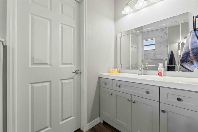 bathroom featuring a shower, vanity, and hardwood / wood-style floors