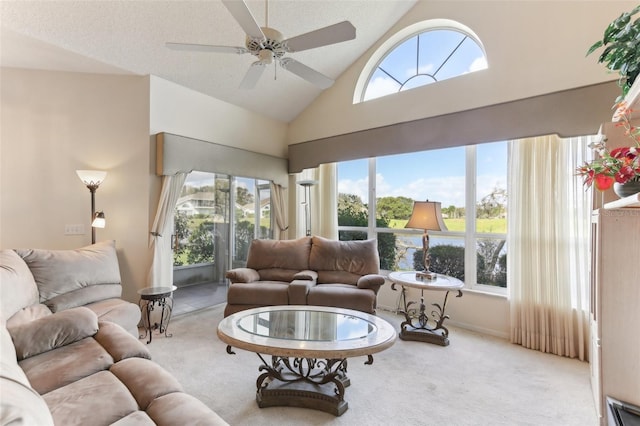 living room featuring a textured ceiling, high vaulted ceiling, light carpet, and ceiling fan