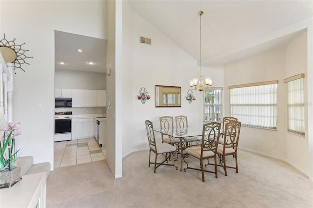 dining space with light carpet, high vaulted ceiling, and a notable chandelier