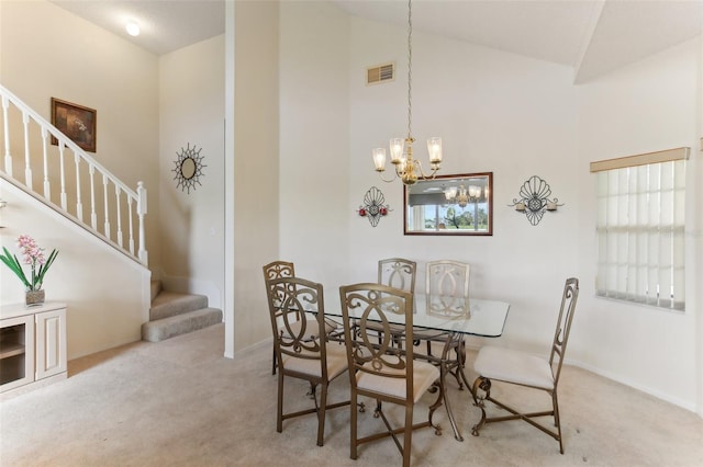 carpeted dining area with high vaulted ceiling and a notable chandelier