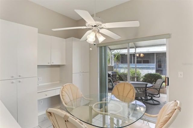 dining space with ceiling fan and vaulted ceiling