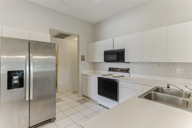 kitchen with stainless steel refrigerator with ice dispenser, sink, light tile patterned flooring, white cabinetry, and white range with electric stovetop