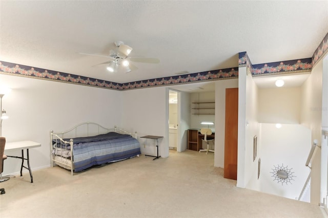 bedroom with ceiling fan, a textured ceiling, and carpet flooring