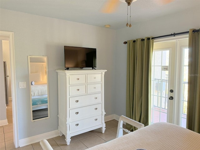 tiled bedroom featuring ceiling fan