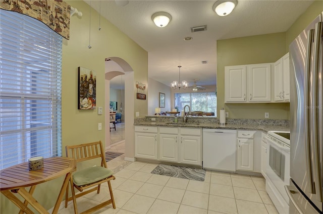 kitchen featuring sink, white cabinetry, and white appliances