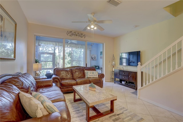 living room with ceiling fan and light tile patterned flooring