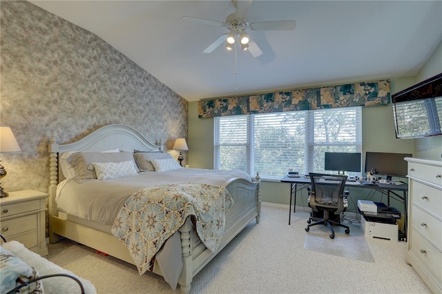 bedroom featuring lofted ceiling, light colored carpet, and ceiling fan