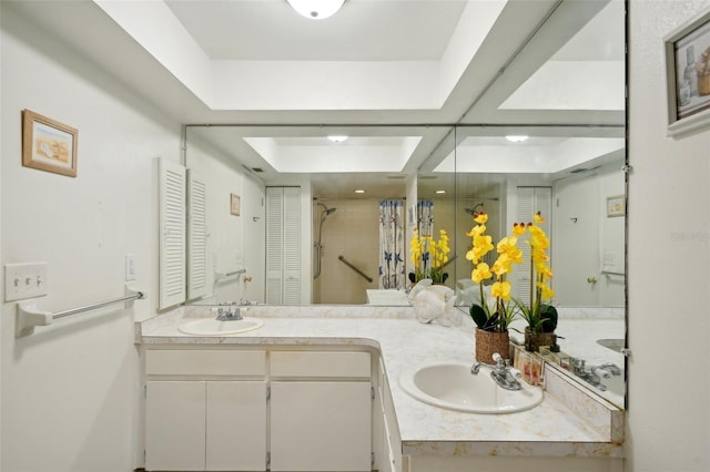 bathroom featuring vanity and curtained shower