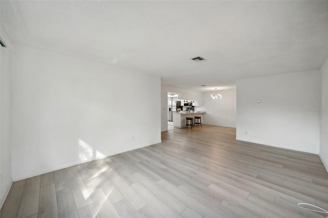 unfurnished living room with light wood-type flooring