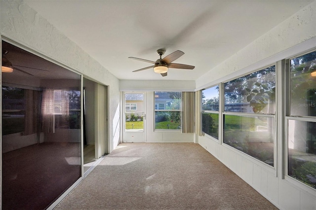 unfurnished sunroom featuring ceiling fan