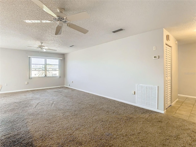 carpeted empty room featuring a textured ceiling and ceiling fan