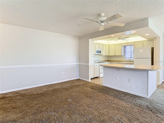 kitchen with sink, a textured ceiling, white appliances, and light colored carpet