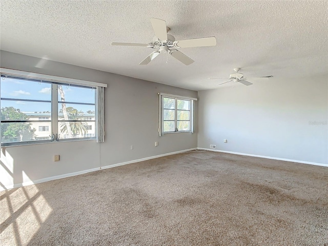 carpeted empty room featuring a textured ceiling and ceiling fan