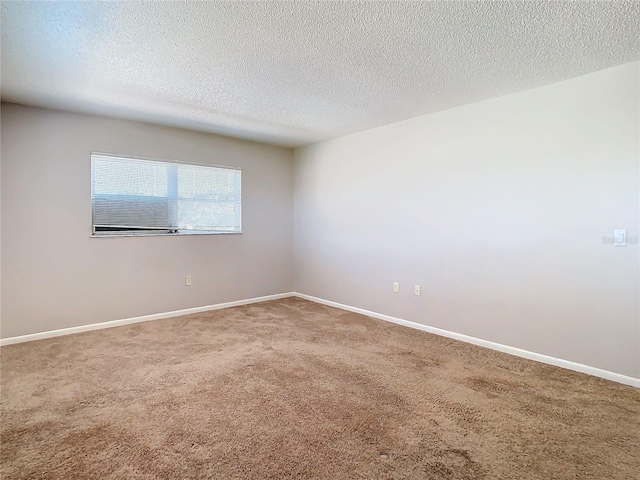 spare room with carpet and a textured ceiling