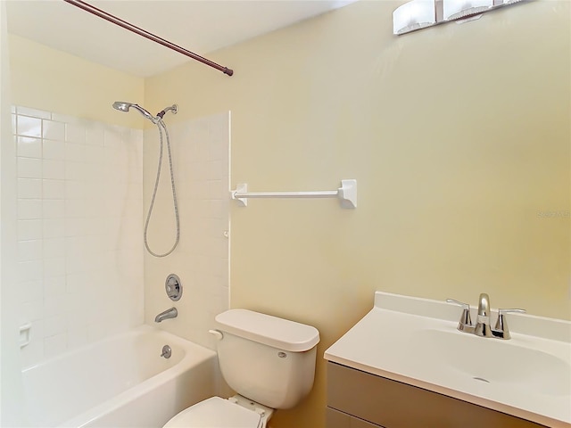 full bathroom with toilet, tiled shower / bath, and vanity