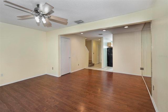 empty room featuring a textured ceiling, light hardwood / wood-style flooring, and ceiling fan