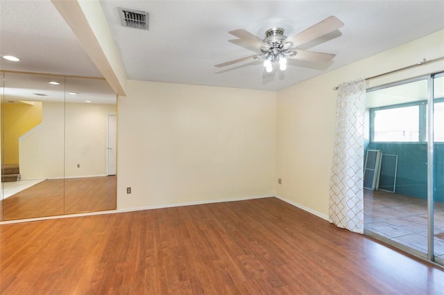 spare room featuring hardwood / wood-style floors and ceiling fan