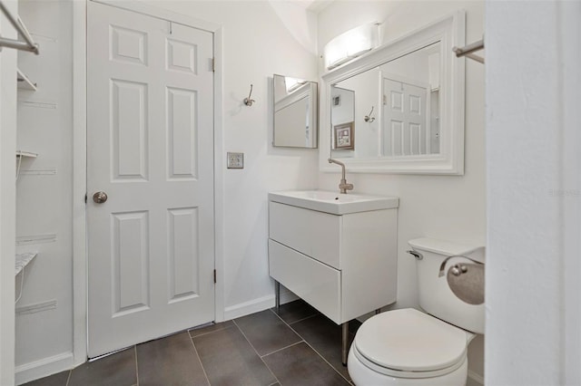 bathroom with vanity, tile patterned flooring, and toilet