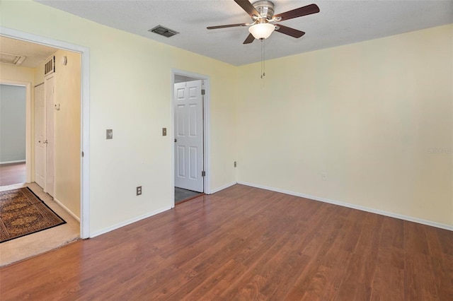 spare room with a textured ceiling, wood-type flooring, and ceiling fan