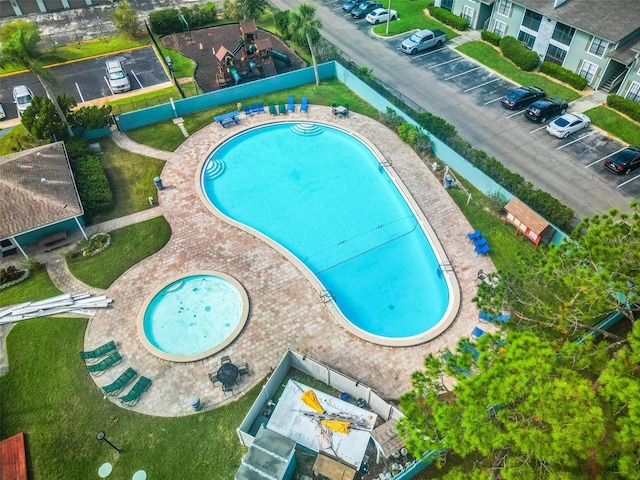 view of swimming pool with a community hot tub