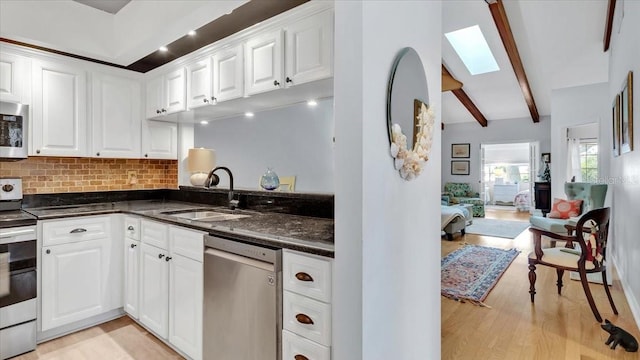 kitchen featuring light hardwood / wood-style floors, white cabinetry, sink, and appliances with stainless steel finishes