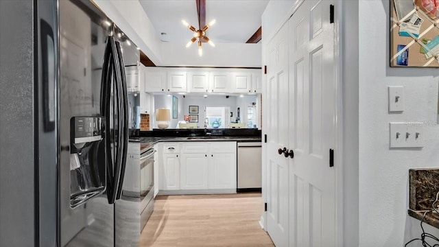 kitchen featuring a chandelier, light hardwood / wood-style flooring, white cabinets, and stainless steel appliances