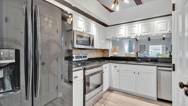 kitchen featuring white cabinetry, sink, light wood-type flooring, and appliances with stainless steel finishes