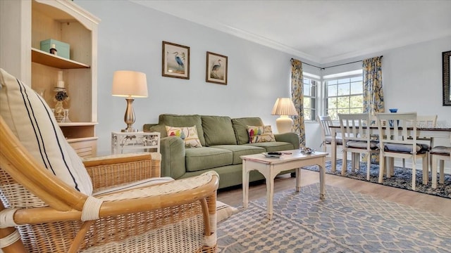 living room featuring crown molding and hardwood / wood-style flooring