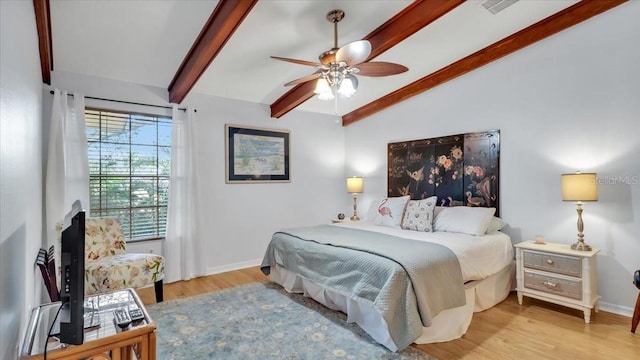 bedroom featuring vaulted ceiling with beams, ceiling fan, and light wood-type flooring