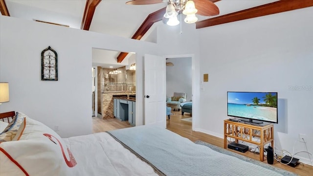 bedroom with high vaulted ceiling, ceiling fan, light wood-type flooring, connected bathroom, and beam ceiling