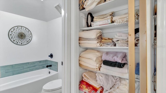 bathroom with a tub and toilet