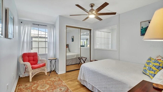 bedroom featuring ceiling fan, a closet, and light hardwood / wood-style flooring