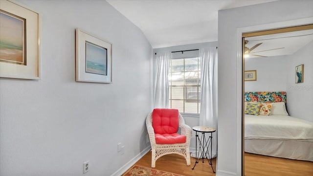 bedroom featuring hardwood / wood-style floors and vaulted ceiling