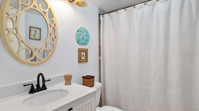 bathroom featuring vanity and toilet