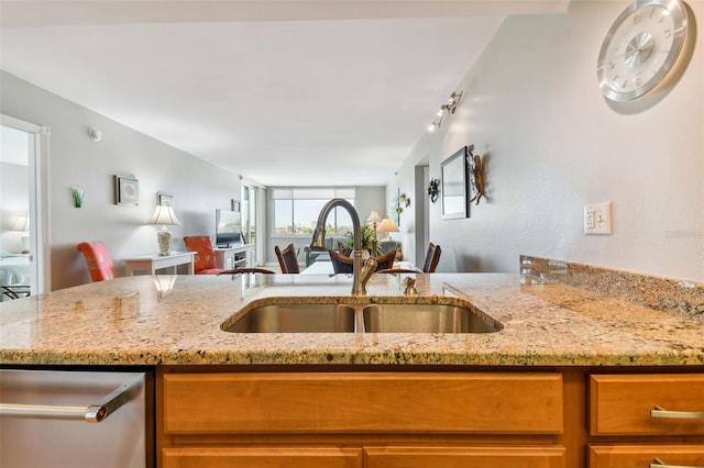 kitchen featuring sink and light stone counters