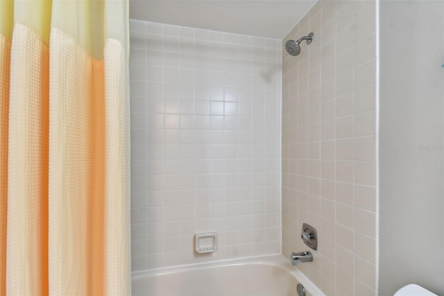 bathroom with shower / bath combination with curtain