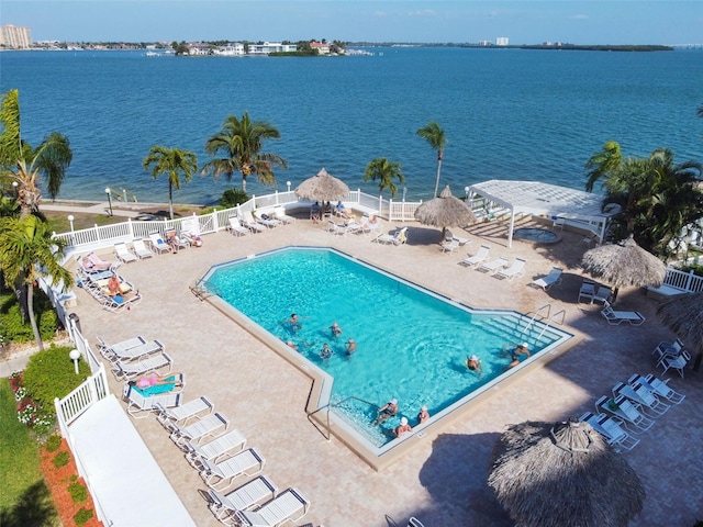 view of pool featuring a patio and a water view