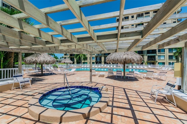 view of pool with a hot tub, a pergola, and a patio area