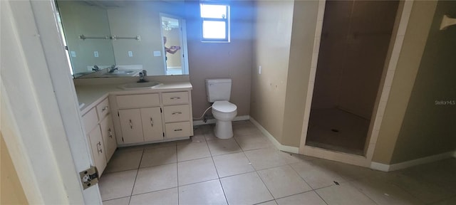 bathroom featuring vanity, toilet, tile patterned floors, and a shower