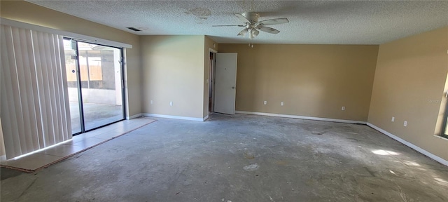 spare room featuring a textured ceiling, concrete flooring, and ceiling fan