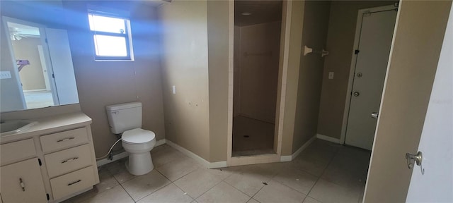 bathroom featuring vanity, toilet, a shower, and tile patterned floors