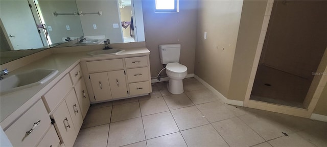 bathroom with toilet, vanity, and tile patterned floors