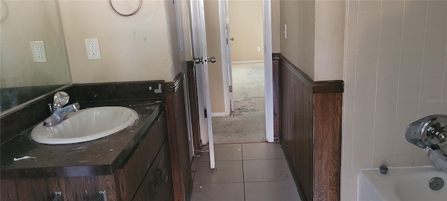 bathroom featuring vanity, tile patterned flooring, and a bathing tub