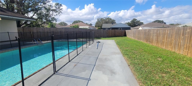 view of swimming pool with a yard and a patio